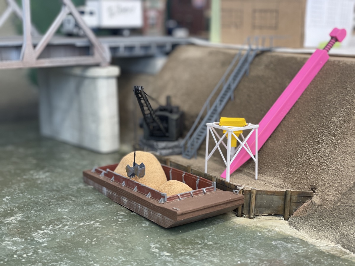 The pink sanding stick is a stand in for a to be built conveyor. It will move sand from barges to the cement plant.