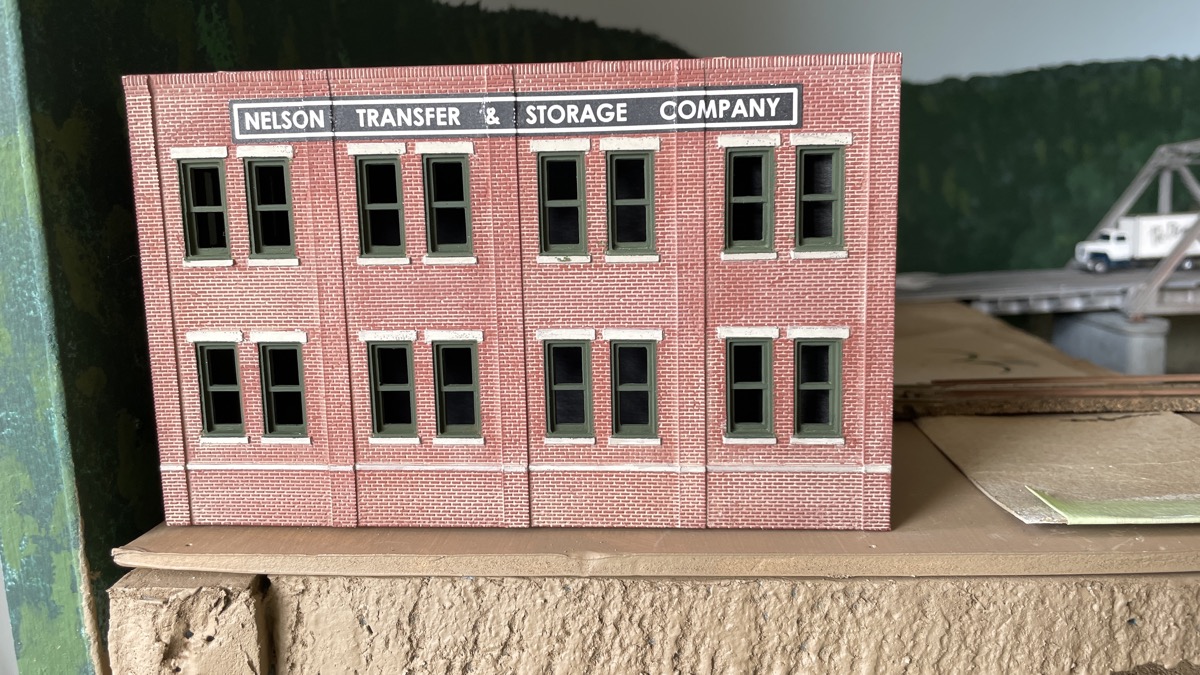 Nelson Moving and Storage buiilding to block view of backdrop hole for trains.