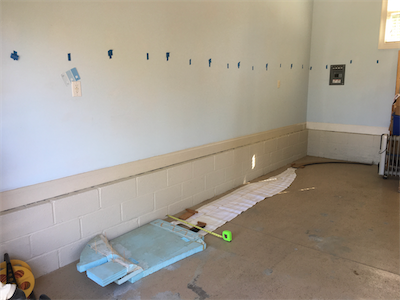 Blue tape on the wall to indicate location of wall studs.