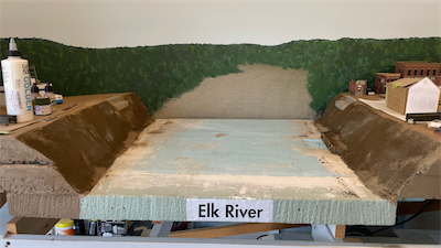 An enlarged photo of the Elk River has been applied to the backdrop.
