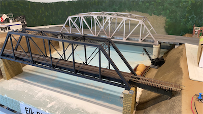 A city street bridge in teh background to help disguist where the river meets the backdrop.