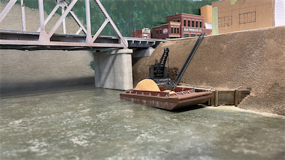 The Pfaff & Smith concrete plant was located on the Elk River. In addition to receiving supplies by rail, the got sand by river barge. Later pictures will show a conveyor to move sand up to the plant.